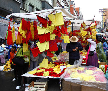 D1NDED LA PAZ, BOLIVIA, 31st December 2012. People shop in a street market for red and yellow underwear, traditionally bought for New Year's Day for good luck in Bolivia. Yellow underwear is said to bring money and success, red is for love, finding a partner, a happy relationship.